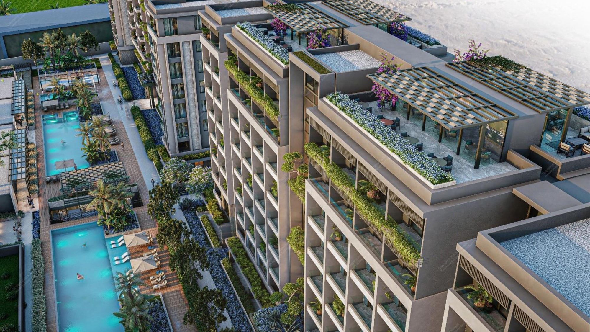 Agora Premium Suites — golden-hour aerial render of the courtyard and pools